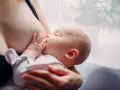 Bambino al seno, un momento intimo che può essere supportato per come aumentare il latte materno.