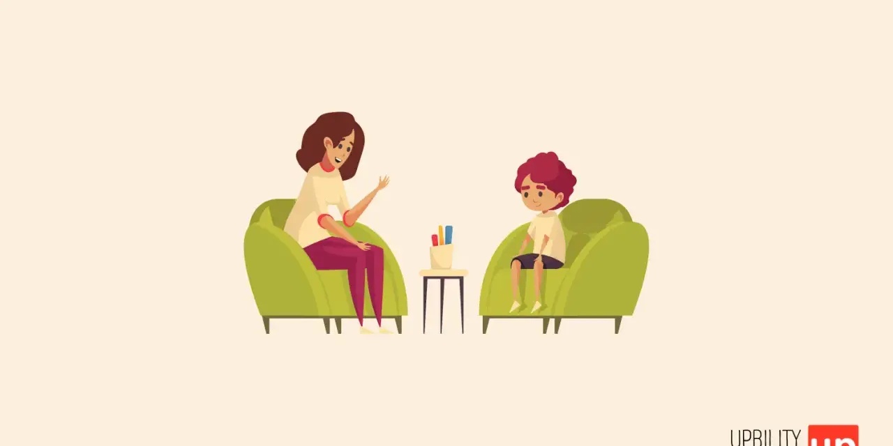 Una psicologa parla con un bambino di 6-7 anni seduti su poltrone verdi.