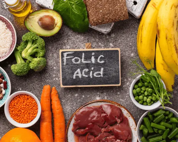 Alimenti ricchi di acido folico, essenziale per la gravidanza: fegato, verdure a foglia verde, legumi, frutta e cereali.