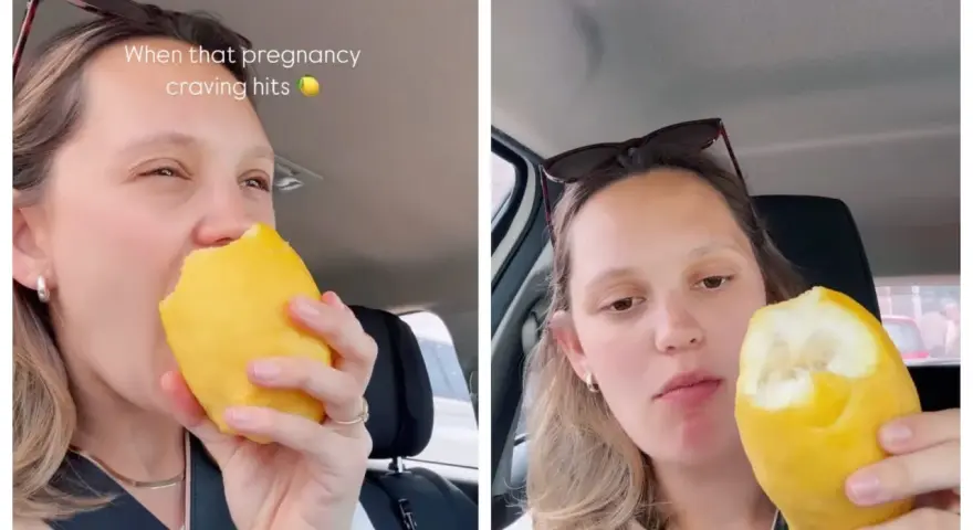 Donna incinta morde un limone intero, soddisfando una strana voglia.